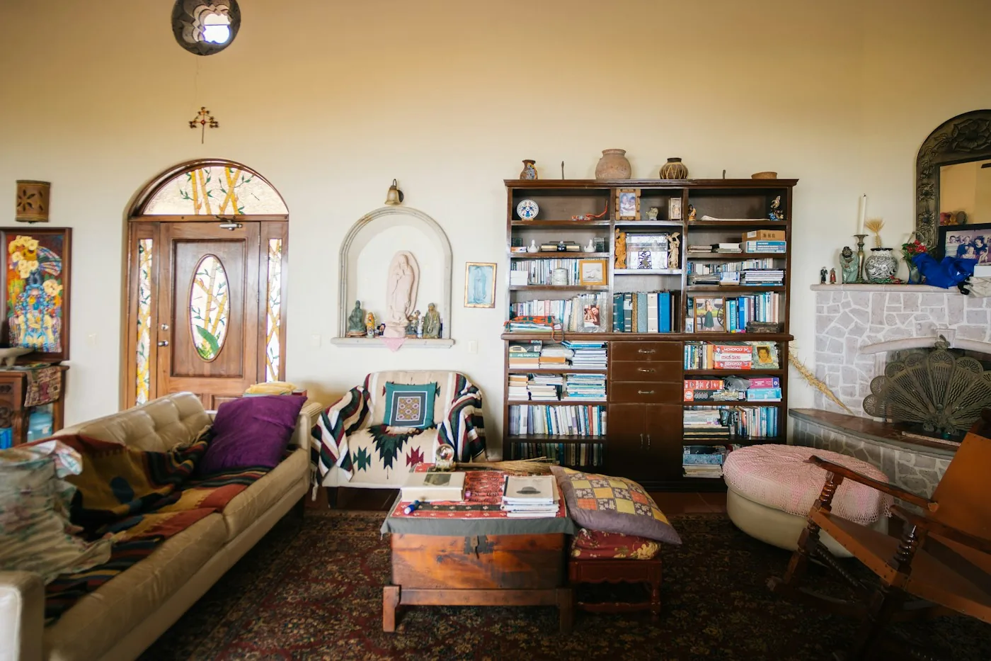 Colorful living room with bookcases and mismatched armchairs