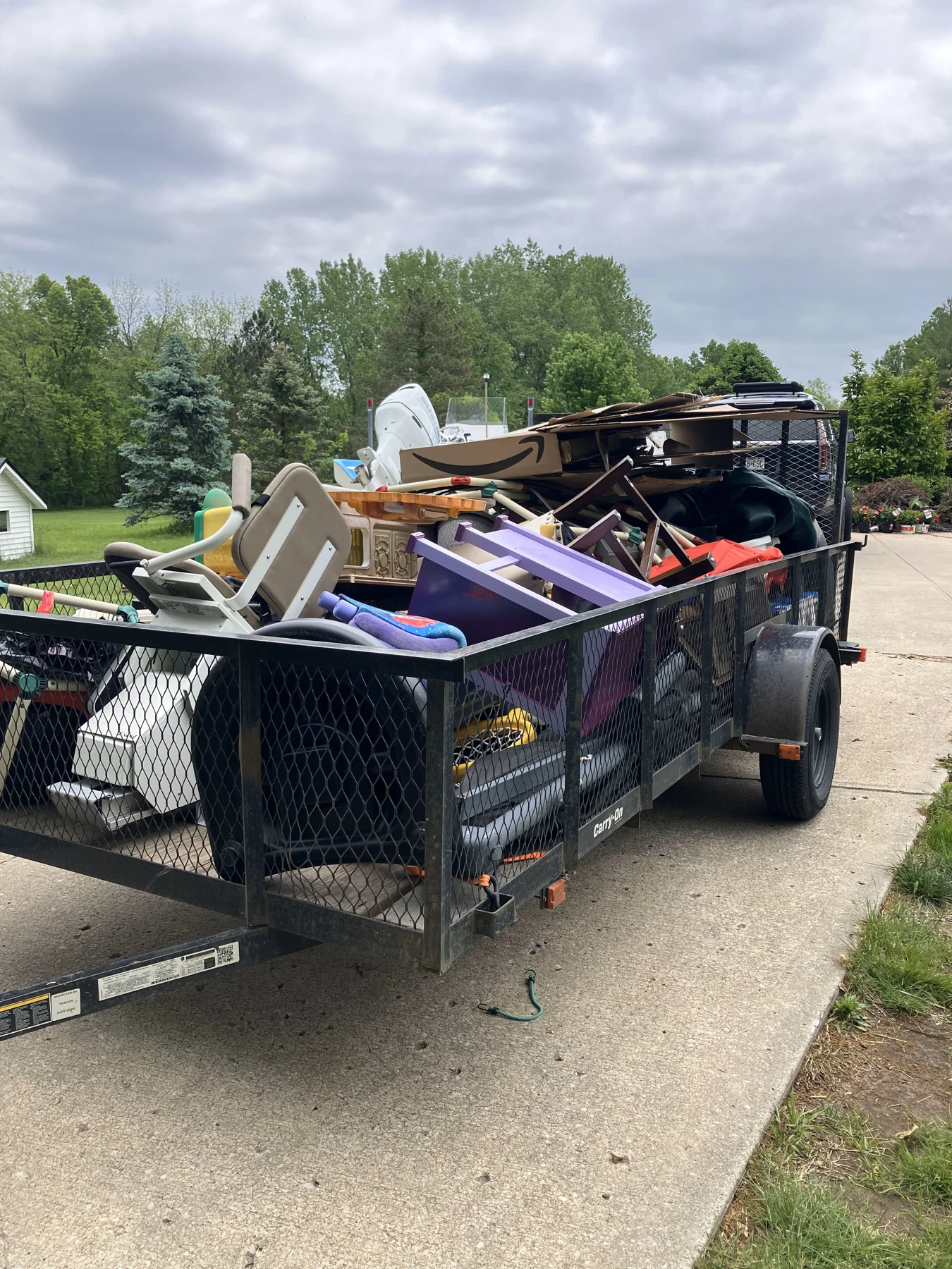 A trailer loaded with furniture and household items after a home cleanout