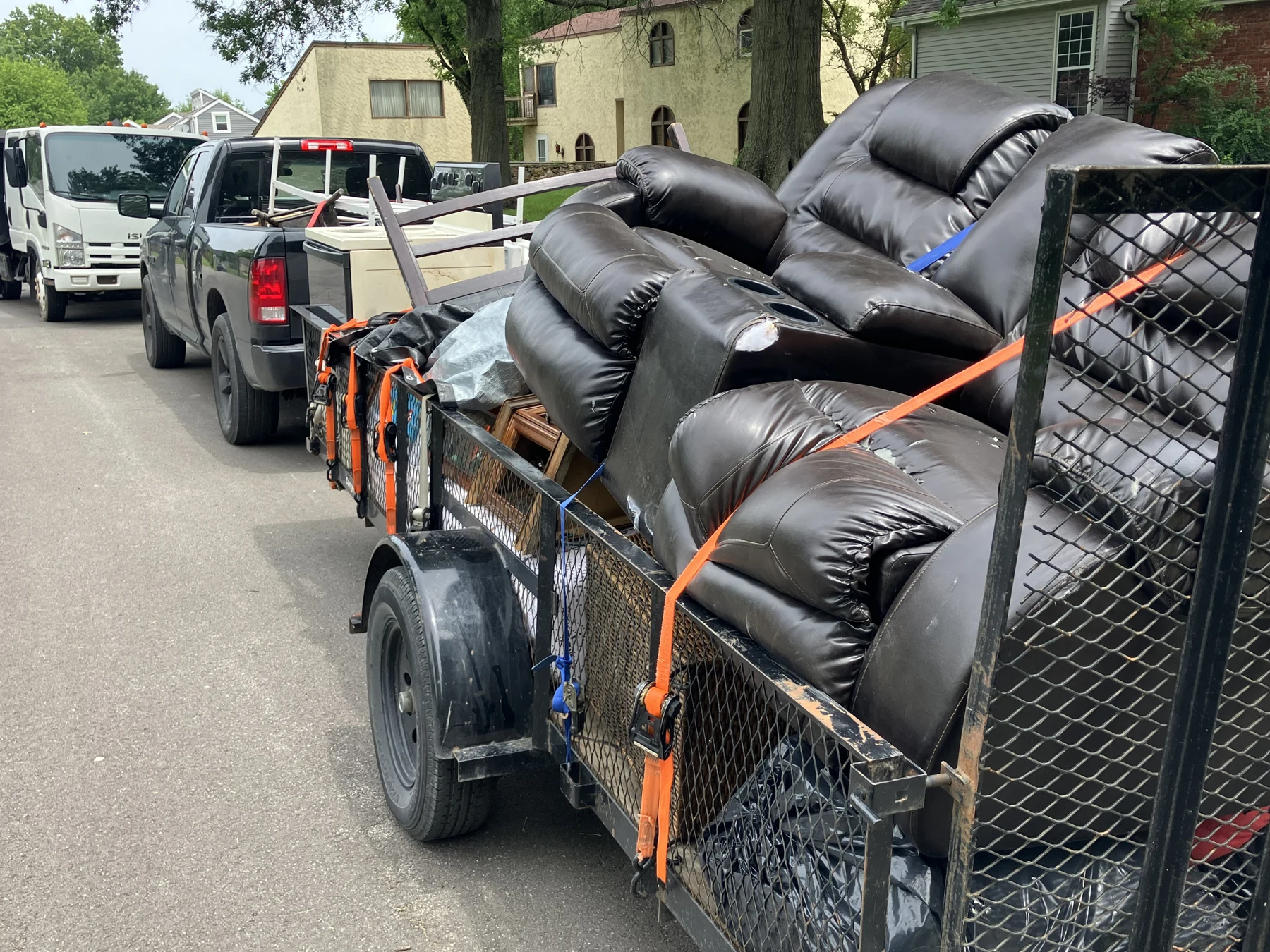 Recliners strapped onto a trailer for removal from a Kansas City home