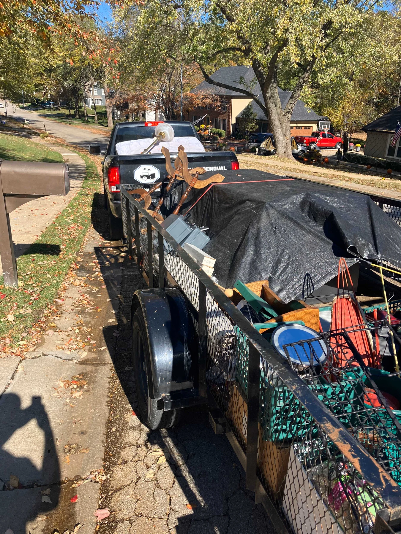 A loaded trailer parked outside a home during a fall cleanout